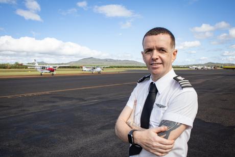 Student standing on runway tarmac