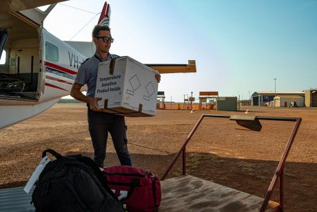 Pilot unoading cargo from plane